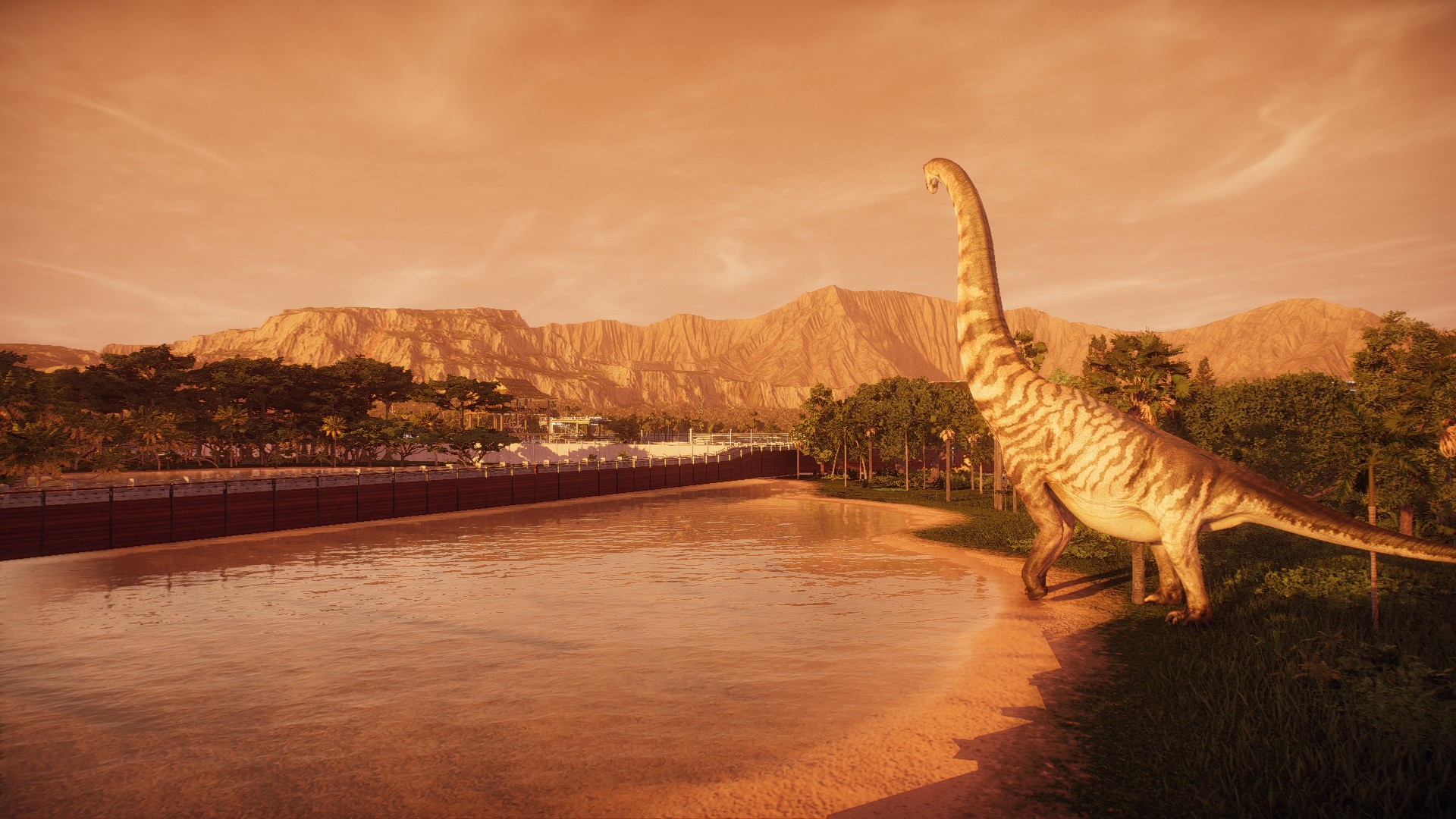 A sauropod strides towards a small lake, stretching high above the mountains on the horizon, sepia in the sunrise.