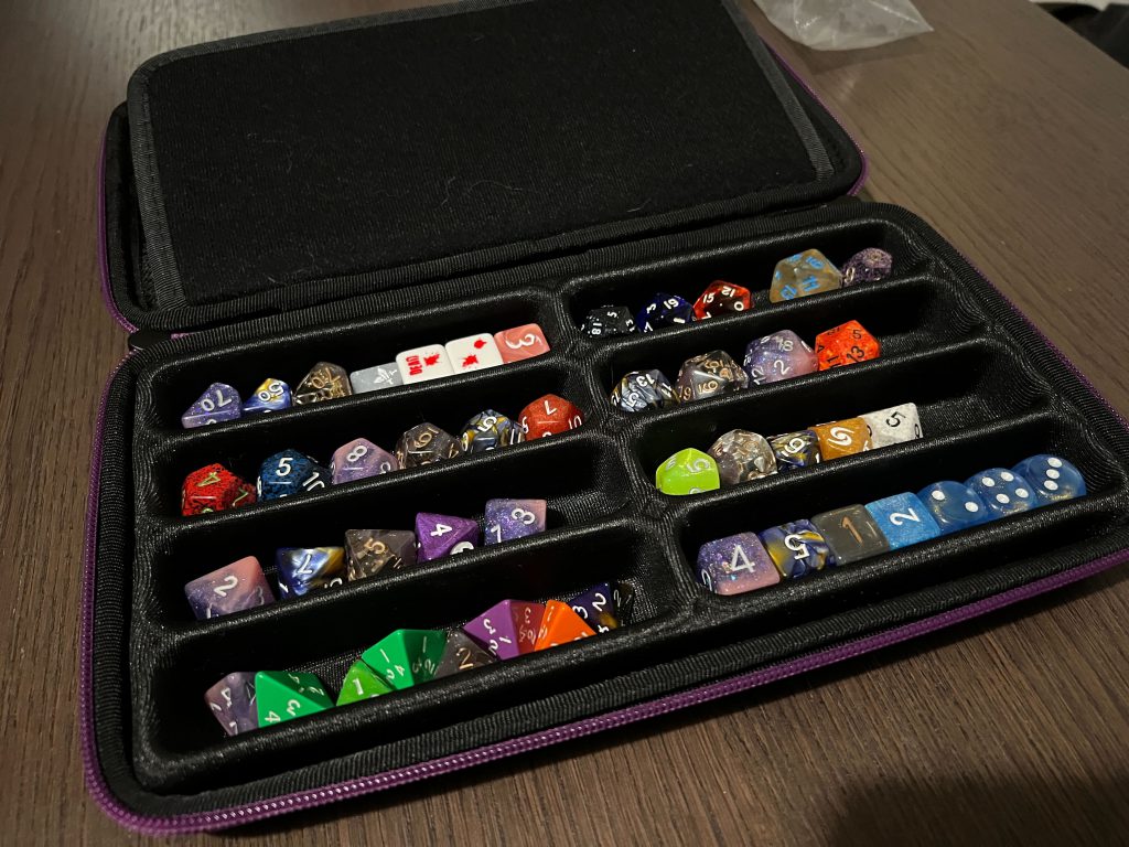 An eight row dice bag, filled with dice, perfect for ttrpg