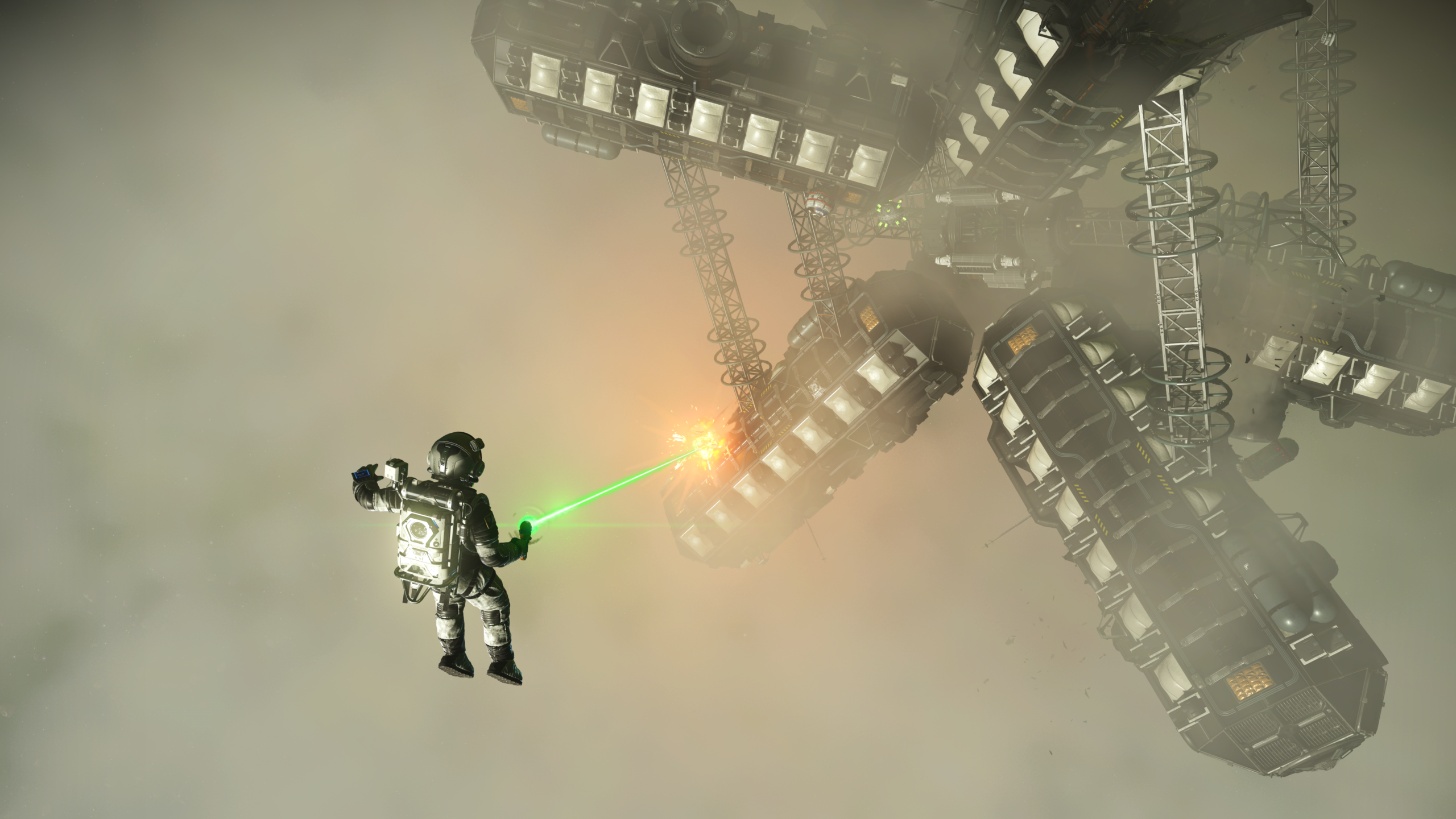 A player floats nearby a giant structure, slicing it with a green laser cutting tool